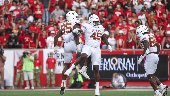 Oct 21, 2023; Houston, Texas, USA;  Texas Longhorns defensive lineman Vernon Broughton (45) and defensive lineman Alfred Collins (95) celebrate after a fumble recovery during the third quarter against the Houston Cougars at TDECU Stadium. Mandatory Credit: Troy Taormina-USA TODAY Sports