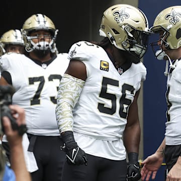 Oct 15, 2023; Houston, Texas, USA; New Orleans Saints linebacker Demario Davis (56) and quarterback Derek Carr (4) prepare to walk onto the field before the game against the Houston Texans at NRG Stadium. Mandatory Credit: Troy Taormina-Imagn Images