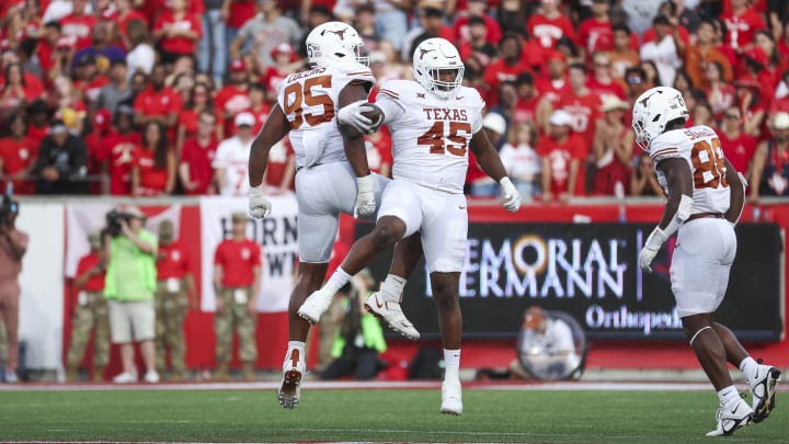 Oct 21, 2023; Houston, Texas, USA;  Texas Longhorns defensive lineman Vernon Broughton (45) and defensive lineman Alfred Collins (95) celebrate after a fumble recovery during the third quarter against the Houston Cougars at TDECU Stadium. Mandatory Credit: Troy Taormina-USA TODAY Sports