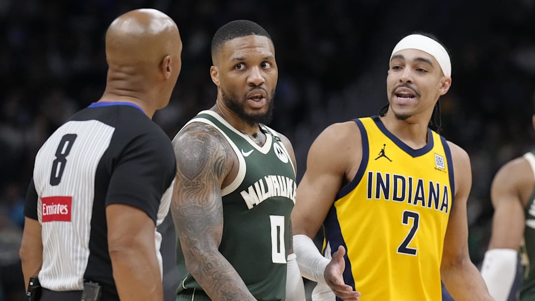 Milwaukee Bucks guard Damian Lillard and Indiana Pacers guard Andrew Nembhard talk with referee Marc Davis during game three of first round for the 2024 NBA Playoffs at Fiserv Forum on Friday.