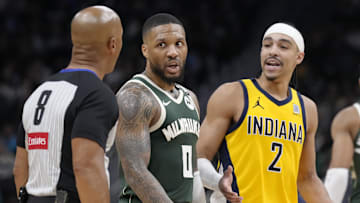 Milwaukee Bucks guard Damian Lillard and Indiana Pacers guard Andrew Nembhard talk with referee Marc Davis during game three of first round for the 2024 NBA Playoffs at Fiserv Forum on Friday.
