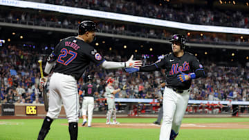 Sep 20, 2024; New York City, New York, USA; New York Mets second baseman Jose Iglesias (11) celebrates his solo home run against the Philadelphia Phillies with third baseman Mark Vientos (27) during the first inning at Citi Field. Mandatory Credit: Brad Penner-Imagn Images