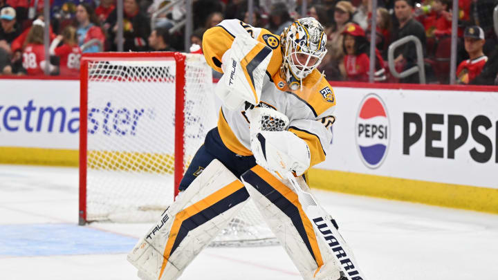 Apr 12, 2024; Chicago, Illinois, USA; Nashville Predators goaltender Kevin Lankinen (32) clears the puck up the ice in the second period against the Chicago Blackhawks at United Center. Mandatory Credit: Jamie Sabau-USA TODAY Sports