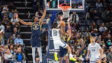 Oct 25, 2025; Memphis, Tennessee, USA; Memphis Grizzlies guard Ja Morant (12) shoots the ball between Indiana Pacers center James Wiseman (11) and guard Ben Sheppard (26) during the second half at FedExForum. Mandatory Credit: Wesley Hale-Imagn Images