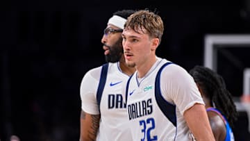 Oct 6, 2025; Fort Worth, Texas, USA; Dallas Mavericks forward/center Anthony Davis (3) hugs forward Cooper Flagg (32) during the game between the Dallas Mavericks and the Oklahoma City Thunder at Dickie's Arena. Mandatory Credit: Jerome Miron-Imagn Images