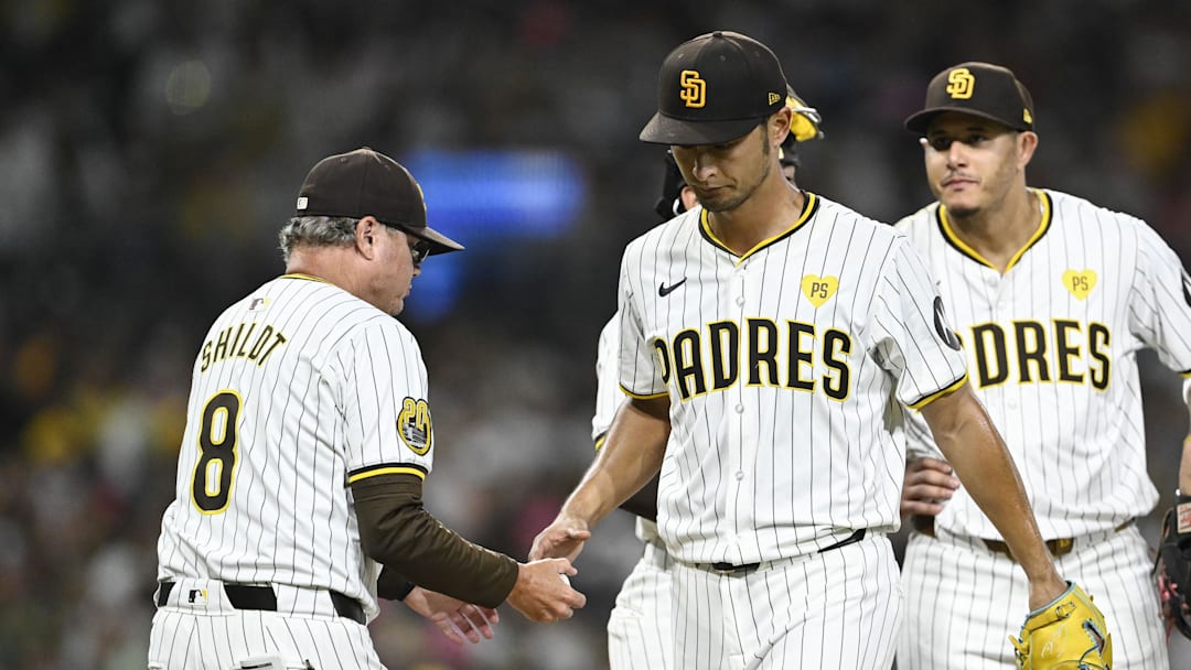Sep 4, 2024; San Diego, California, USA; San Diego Padres starting pitcher Yu Darvish (11) hands the ball to the manager Mike Shildt as he leaves the game during the third inning against the Detroit Tigers at Petco Park. Mandatory Credit: Denis Poroy-Imagn Images