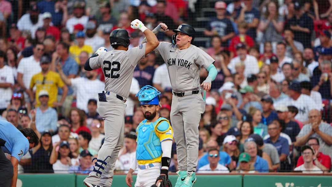 Jul 27, 2024; Boston, Massachusetts, USA; New York Yankees right fielder Alex Verdugo (24) bumps forearms with New York Yankees left fielder Juan Soto (22) to congratulate him for hitting a two-run home run against the Boston Red Sox during the first inning at Fenway Park. Mandatory Credit: Gregory Fisher-Imagn Images