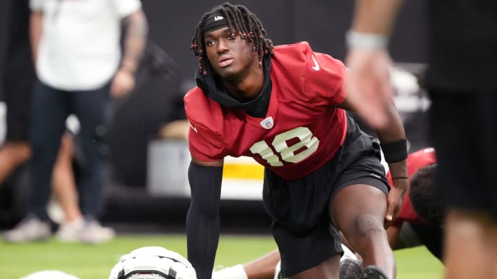 Arizona Cardinals receiver Marvin Harrison Jr. (18) stretches during the team's training camp session at State Farm Stadium in Glendale on July 24, 2024.