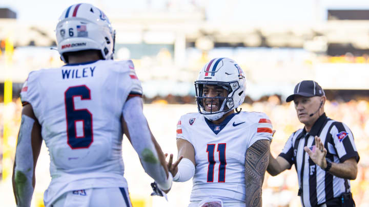 Nov 25, 2023; Tempe, Arizona, USA; Arizona Wildcats running back Michael Wiley (6) celebrates with quarterback Noah Fifita (11) after scoring a touchdown against the Arizona State Sun Devils during the Territorial Cup at Mountain America Stadium.