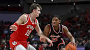 Jan 22, 2025; Houston, Texas, USA; Houston Cougars guard Mercy Miller (25) drives against Utah Utes forward Jake Wahlin (10) during the second half at Fertitta Center. The Cougars defeated the Utes 70-36. Mandatory Credit: Maria Lysaker-Imagn Images  