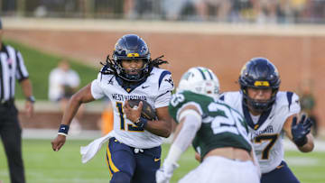 Sep 6, 2025; Athens, Ohio, USA; West Virginia Mountaineers quarterback Jaylen Henderson (13) runs the ball during the fourth quarter against the Ohio Bobcats at Peden Stadium. Mandatory Credit: Ben Queen-Imagn Images