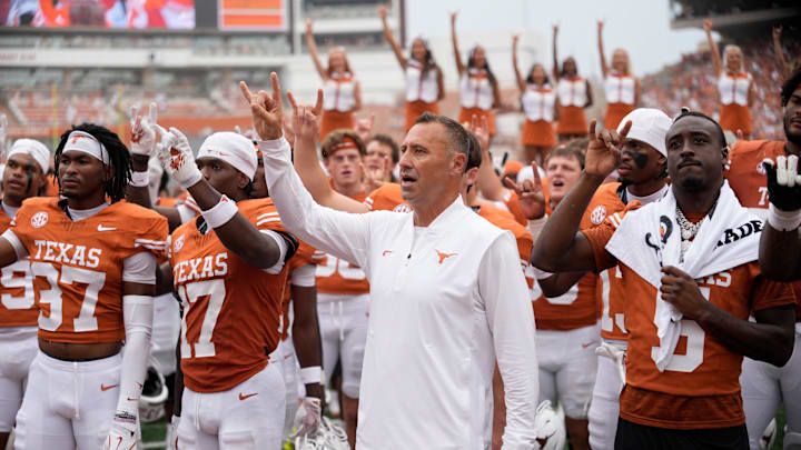 Texas Longhorns head coach Steve Sarkisian and players hold up their horns with the fans during the singing of the Eyes of Texas after a victory over the San Jose State Spartans Texas Longhorns head coach Steve Sarkisian and players hold up their horns with the fans during the singing of the Eyes of Texas after a victory over the San Jose State Spartans