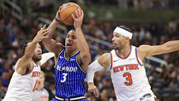 Nov 22, 2025; Orlando, Florida, USA; Orlando Magic guard Desmond Bane (3) drives to the basket past New York Knicks guard Jalen Brunson (11) and guard Josh Hart (3) in the fourth quarter at Kia Center. Mandatory Credit: Nathan Ray Seebeck-Imagn Images