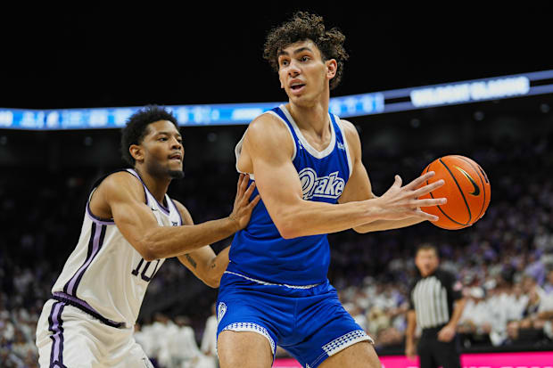 Abreu controls the basketball against Kansas State guard David Castillo during a game this season.