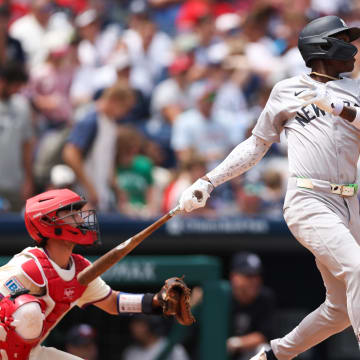 Jul 31, 2024; Philadelphia, Pennsylvania, USA;  New York Yankees third base Jazz Chisholm Jr. (13) hits a single during the second inning against the Philadelphia Phillies at Citizens Bank Park. Mandatory Credit: Bill Streicher-USA TODAY Sports