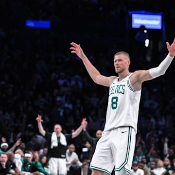 Mar 15, 2025; Brooklyn, New York, USA; Boston Celtics center Kristaps Porzingis (8) reacts after a three point basket during the second half against the Brooklyn Nets at Barclays Center. Mandatory Credit: John Jones-Imagn Images
