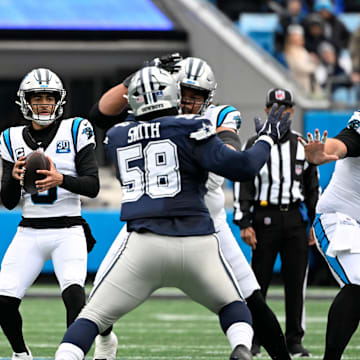 Dec 15, 2024; Charlotte, North Carolina, USA;  Carolina Panthers quarterback Bryce Young (9) looks to pass as Dallas Cowboys defensive tackle Mazi Smith (58) pressures in the first quarter at Bank of America Stadium. Mandatory Credit: Bob Donnan-Imagn Images