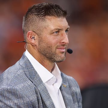 Aug 30, 2025; Atlanta, Georgia, USA; SEC Network analyst Tim Tebow on the field before a game between the Tennessee Volunteers and Syracuse Orange at Mercedes-Benz Stadium. Mandatory Credit: Brett Davis-Imagn Images
