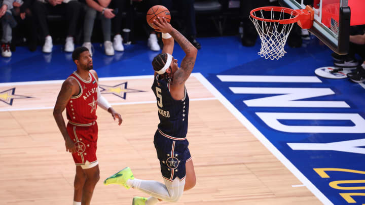 Eastern Conference forward Paolo Banchero (5) of the Orlando Magic dunks the ball past Western Conference forward Paul George (13) of the LA Clippers during the second quarter in the 73rd NBA All Star game at Gainbridge Fieldhouse. 