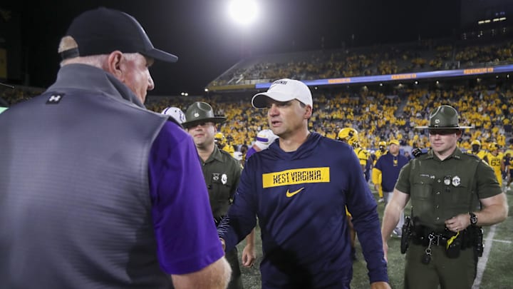 West Virginia Mountaineers head coach Neal Brown speaks with Albany Great Danes head coach Greg Gattuso after the game at Mountaineer Field at Milan Puskar Stadium. 