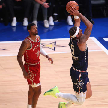 Feb 18, 2024; Indianapolis, Indiana, USA; Eastern Conference forward Paolo Banchero (5) of the Orlando Magic dunks the ball past Western Conference forward Paul George (13) of the LA Clippers during the second quarter in the 73rd NBA All-Star game at Gainbridge Fieldhouse.