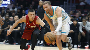 Mar 10, 2025; Miami, Florida, USA;  Charlotte Hornets guard Malachi Flynn (22) steals the ball from Miami Heat guard Tyler Herro (14) during the second half at Kaseya Center. Mandatory Credit: Rhona Wise-Imagn Images