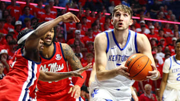 Feb 4, 2025; Oxford, Mississippi, USA; Kentucky Wildcats forward Andrew Carr (7) drives to the basket as Mississippi Rebels guard Jaylen Murray (5) defends during the first half at The Sandy and John Black Pavilion at Ole Miss. Mandatory Credit: Petre Thomas-Imagn Images