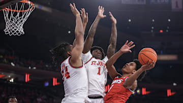 Nov 17, 2024; New York, New York, USA; New Mexico Lobos guard Tru Washington (3) looks to drive past St. John's basketball forward Zuby Ejiofor (24) and guard Kadary Richmond (1) in the first half at Madison Square Garden.