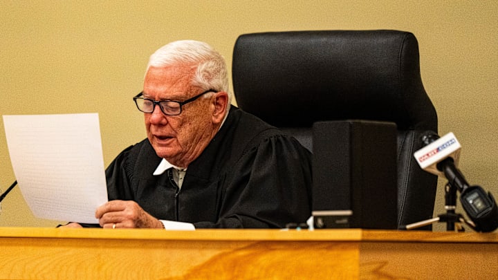 Lafayette County Chancery Court Judge Robert Whitwell reads aloud his decision during the hearing of Ole Miss quarterback Trinidad Chambliss in his lawsuit against the NCAA at Calhoun County Courthouse in Pittsboro, Miss., on Thursday, Feb. 12, 2026. Chambliss was granted a preliminary injunction against the NCAA.