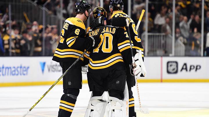 Nov 7, 2024; Boston, Massachusetts, USA;  Boston Bruins defenseman Mason Lohrei (6) and defenseman Nikita Zadorov (91) celebrate with goaltender Joonas Korpisalo (70) after defeating the Calgary Flames in overtime at TD Garden. Mandatory Credit: Bob DeChiara-Imagn Images