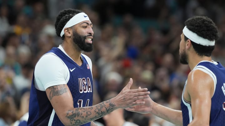 Jul 28, 2024; Villeneuve-d'Ascq, France; United States centre Anthony Davis (14) celebrates with guard Devin Booker (15) in the fourth quarter against Serbia during the Paris 2024 Olympic Summer Games at Stade Pierre-Mauroy. Mandatory Credit: John David Mercer-USA TODAY Sports