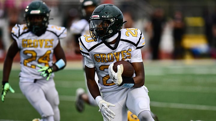 Birmingham Groves' Noah Sanders rushes during an Oakland Activities Association crossover football game Friday, Aug. 25, 2023. Birmingham Groves' Noah Sanders rushes during an Oakland Activities Association crossover football game Friday, Aug. 25, 2023.