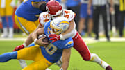 Sep 29, 2024; Inglewood, California, USA;  Los Angeles Chargers quarterback Justin Herbert (10) is sacked by Kansas City Chiefs linebacker Leo Chenal (54) in the first half at SoFi Stadium. Mandatory Credit: Jayne Kamin-Oncea-Imagn Images