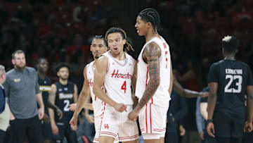 Houston Cougars guard Kingston Flemings (4) celebrates with teammates after scoring during the second half against the Towson Tigers at Fertitta Center.