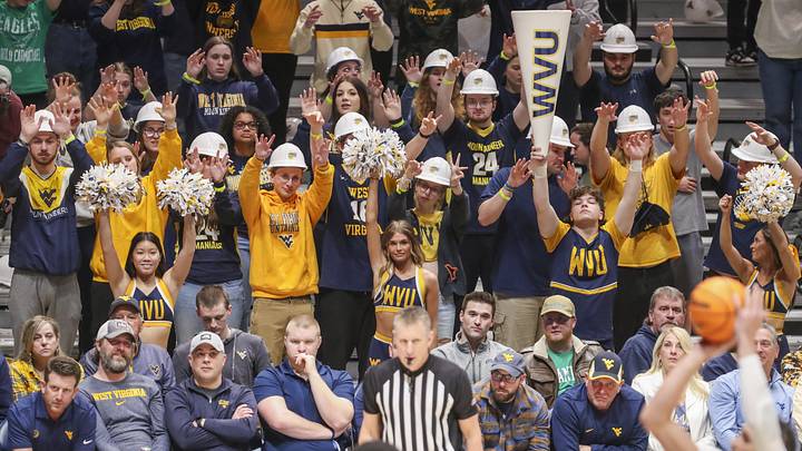 Mar 2, 2024; Morgantown, West Virginia, USA; West Virginia Mountaineers students pause during a foul shot during the first half against the Texas Tech Red Raiders at WVU Coliseum. Mandatory Credit: Ben Queen-Imagn Images