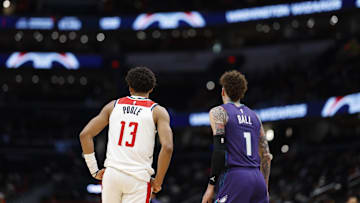 Dec 19, 2024; Washington, District of Columbia, USA; Washington Wizards guard Jordan Poole (13) stands next to Charlotte Hornets guard LaMelo Ball (1) on the court in the third quarter at Capital One Arena. Mandatory Credit: Geoff Burke-Imagn Images
