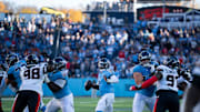 Tennessee quarterback Cam Ward (1) makes a break for the hole in the Houston defensive line during their game at Nissan Stadium in Nashville, Tenn., Sunday, Nov. 16, 2025. The Titans scored a touchdown on the next play and tied the game with a Tennessee place kicker Joey Slye (6) extra point. With about 1:30 to go in the game, Houston moved down the field and kicked a game-winning field goal to run out the clock. The final score: Texans 16 - Titans 13.