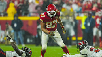 Nov 4, 2024; Kansas City, Missouri, USA; Tampa Bay Buccaneers safety Josh Hayes (32) dives for a pass intended for Kansas City Chiefs tight end Travis Kelce (87) during the second half at GEHA Field at Arrowhead Stadium. Mandatory Credit: Jay Biggerstaff-Imagn Images