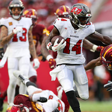 Sep 8, 2024; Tampa, Florida, USA; Tampa Bay Buccaneers wide receiver Chris Godwin (14) runs with the ball against the Washington Commanders in the fourth quarter at Raymond James Stadium. Mandatory Credit: Nathan Ray Seebeck-Imagn Images