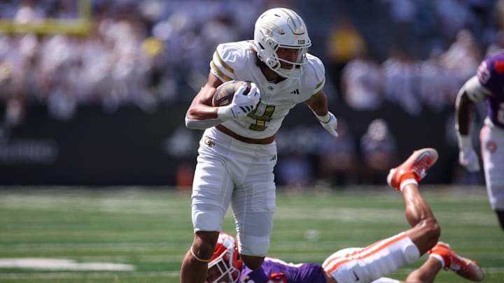 Sep 13, 2025; Atlanta, Georgia, USA; Georgia Tech Yellow Jackets wide receiver Isiah Canion (4) runs past Clemson Tigers safety Ricardo Jones (6) after a catch in the first quarter at Bobby Dodd Stadium at Hyundai Field. Mandatory Credit: Brett Davis-Imagn Images
