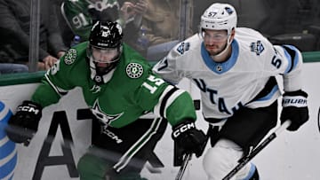 Apr 12, 2025; Dallas, Texas, USA; Dallas Stars center Colin Blackwell (15) and Utah Hockey Club defenseman Nick DeSimone (57) chase the puck lduring the third period at the American Airlines Center. Mandatory Credit: Jerome Miron-Imagn Images