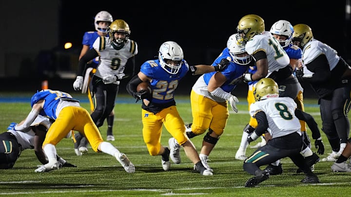 Mukwonago's Mason Radobicky (22) cuts through a gap during the WIAA Level 2 playoff game at home against Racine Case on Friday, Nov. 1, 2024. Mukwonago's Mason Radobicky (22) cuts through a gap during the WIAA Level 2 playoff game at home against Racine Case on Friday, Nov. 1, 2024.