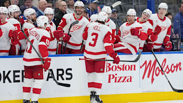 Apr 17, 2025; Toronto, Ontario, CAN; Detroit Red Wings defenseman Justin Holl (3) celebrate at the bench after scoring a goal against the Toronto Maple Leafs during the second period at Scotiabank Arena. Mandatory Credit: Nick Turchiaro-Imagn Images