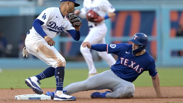 Jun 13, 2024; Los Angeles, California, USA;  Texas Rangers third baseman Josh Smith (8) beats the tag by Los Angeles Dodgers shortstop Mookie Betts (50) for a stolen base in the first inning at Dodger Stadium. Mandatory Credit: Jayne Kamin-Oncea-USA TODAY Sports