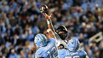 Nov 16, 2024; Chapel Hill, North Carolina, USA;  DUPLICATE***North Carolina Tar Heels defensive lineman Beau Atkinson (12)***North Carolina Tar Heels quarterback Jacolby Criswell (12) has his pass tipped in the third quarter at Kenan Memorial Stadium. Mandatory Credit: Bob Donnan-Imagn Images