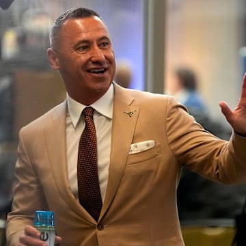 July 15, 2025; Atlanta, GA, USA; Texas head coach Steve Sarkisian waves to fans during SEC Media Days at the College Football Hall of Fame in Atlanta.