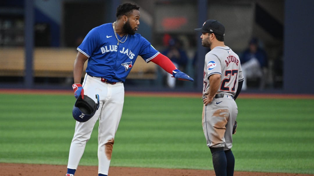 Jul 2, 2024; Toronto, Ontario, CAN;  Toronto Blue Jays first baseman Vladimir Guerrero Jr. (27) gestures as he speaks with Houston Astros second baseman Jose Altuve (27) in the third inning at Rogers Centre.