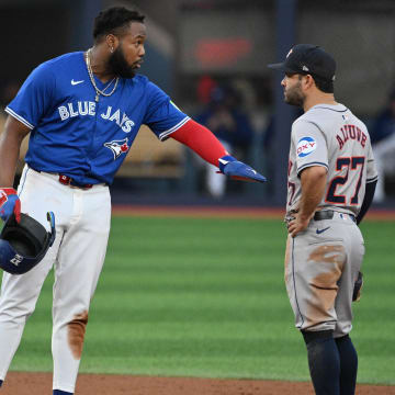 Jul 2, 2024; Toronto, Ontario, CAN;  Toronto Blue Jays first baseman Vladimir Guerrero Jr. (27) gestures as he speaks with Houston Astros second baseman Jose Altuve (27) in the third inning at Rogers Centre.