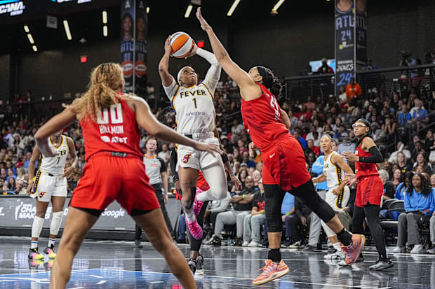 Indiana Fever guard Odyssey Sims shoots against Atlanta Dream forward Brionna Jones. 