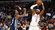 Mar 5, 2025; Memphis, Tennessee, USA; Oklahoma City Thunder guard Shai Gilgeous-Alexander (2) shoots as Memphis Grizzlies guard Ja Morant (12) defends during the first quarter at FedExForum. Mandatory Credit: Petre Thomas-Imagn Images